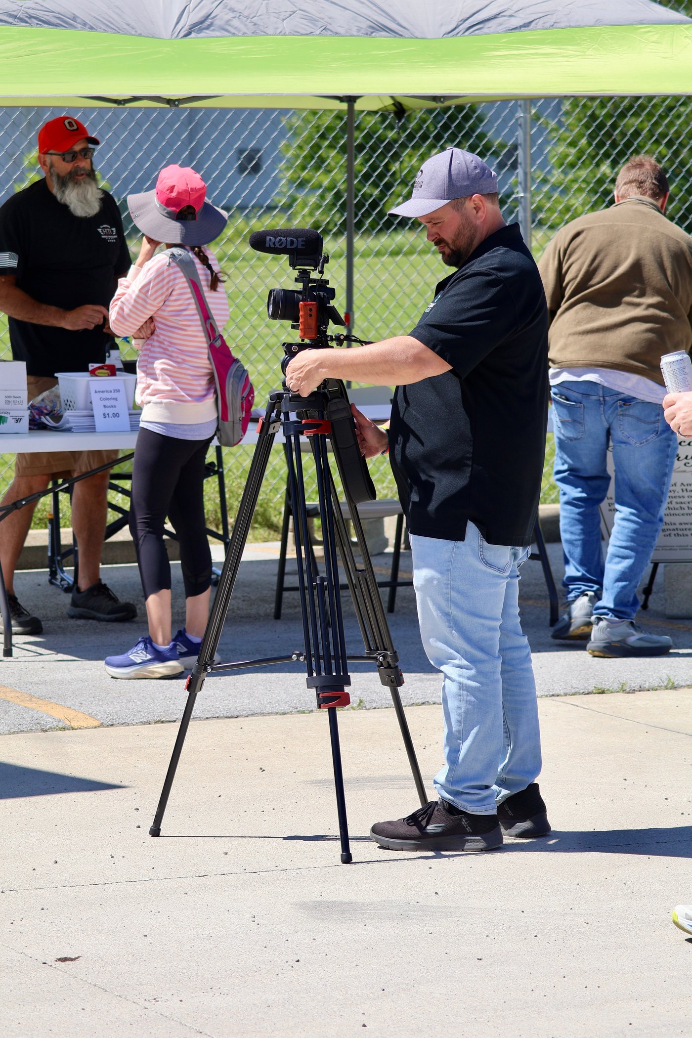 Gideon Fisher setting up a cinema camera at a community event